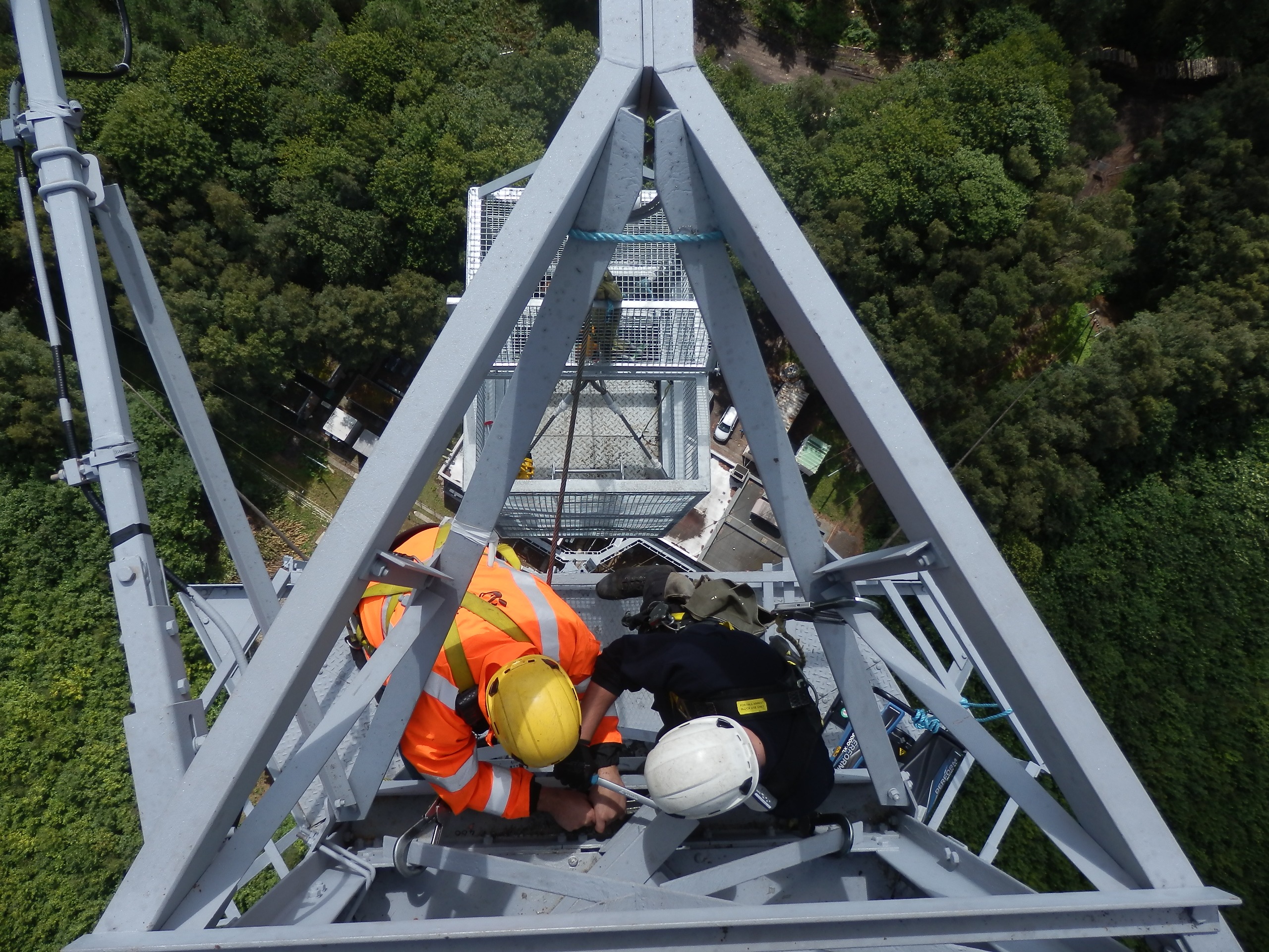 2 men work on a boradcast tower at midhurst