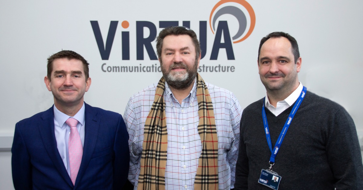 justin, dave, paul stand in front of virtua logo