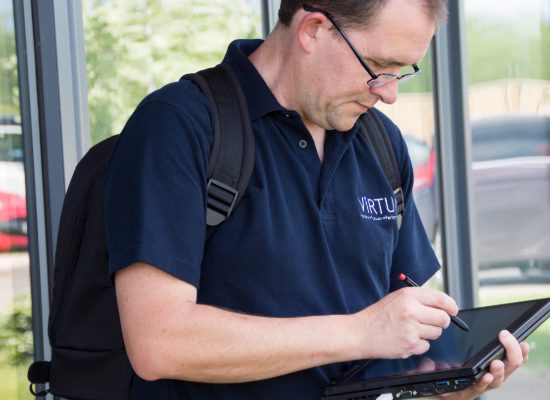 man surveys building for cellular coverage